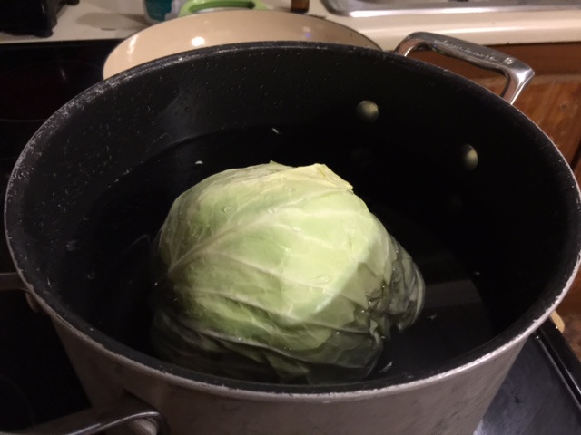 Boiling cabbage to separate the leaves.